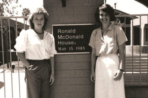 Two women, the original staff of RMHC Phoenix, stand in front of the Roanoke House dedication plaque