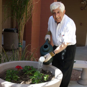 Gus Kapellas watering the plants in the garden