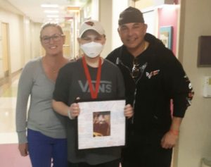 Mom, dad, and son pose for a picture in the hospital