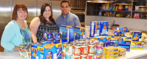 Three RMHC supporters with donated food items