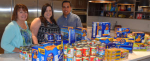 Three RMHC supporters with donated food items