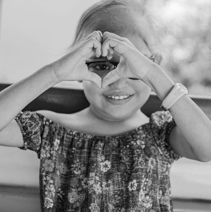Little girl with hands in the shape of a heart
