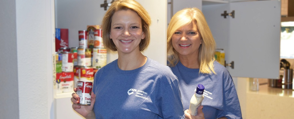 Two female volunteers organize the pantry in the kitchen